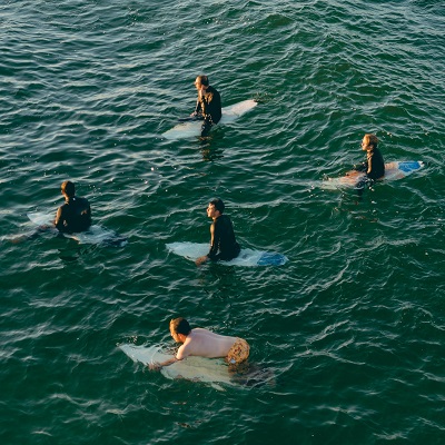 5 surfers in water