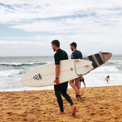 two guys with surfboards