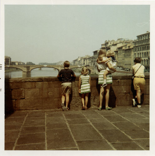 family looking at river from bridge