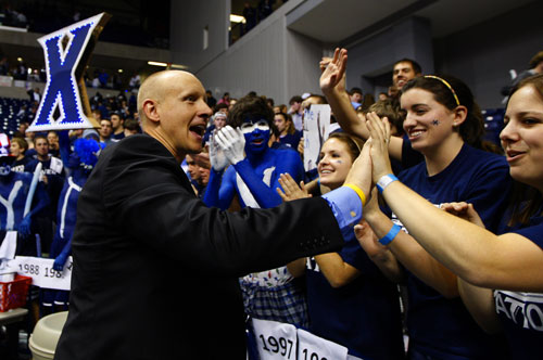 executive interacting with fans at basketball game