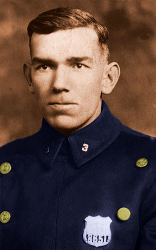 sepia-tone picture of cpo with colorized blue jacket with gold butons