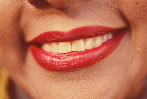 picture of woman's lips covered in red lipstick