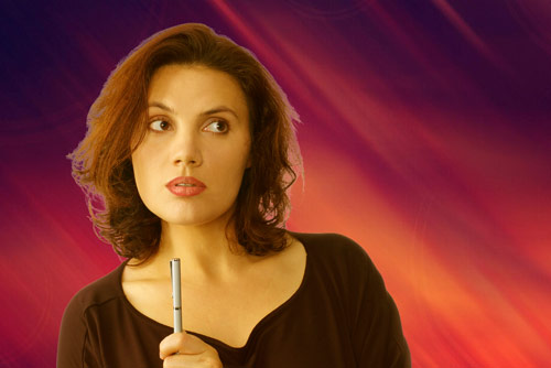 inquisitive woman holding pen with abstract red and purple background